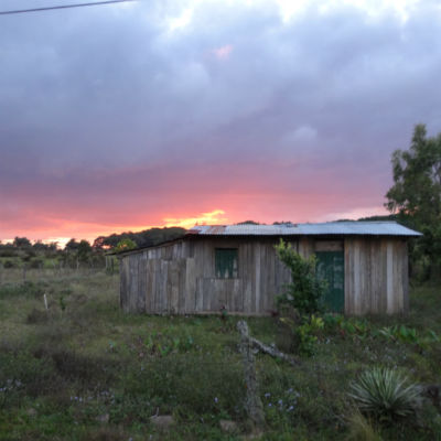 Sun sets over a country hut