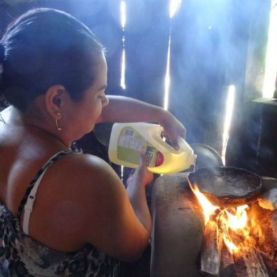Woman cooking over wood fire