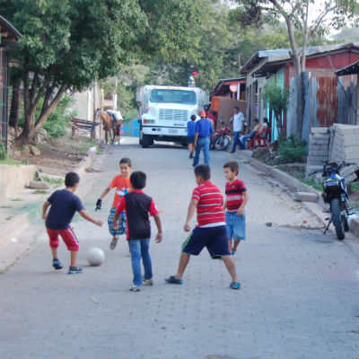 Kids playing soccer in the street